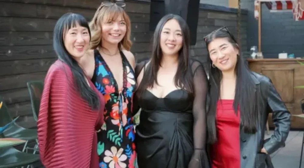 Four women together at a community event